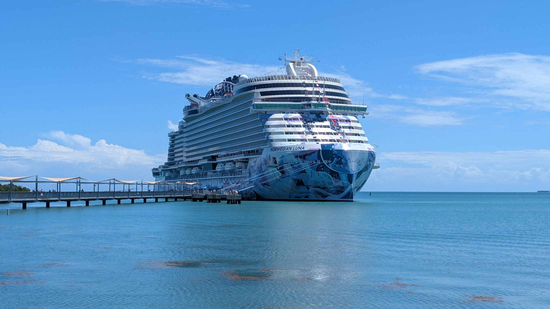 Cruise ship docked in bright blue Caribbean water
