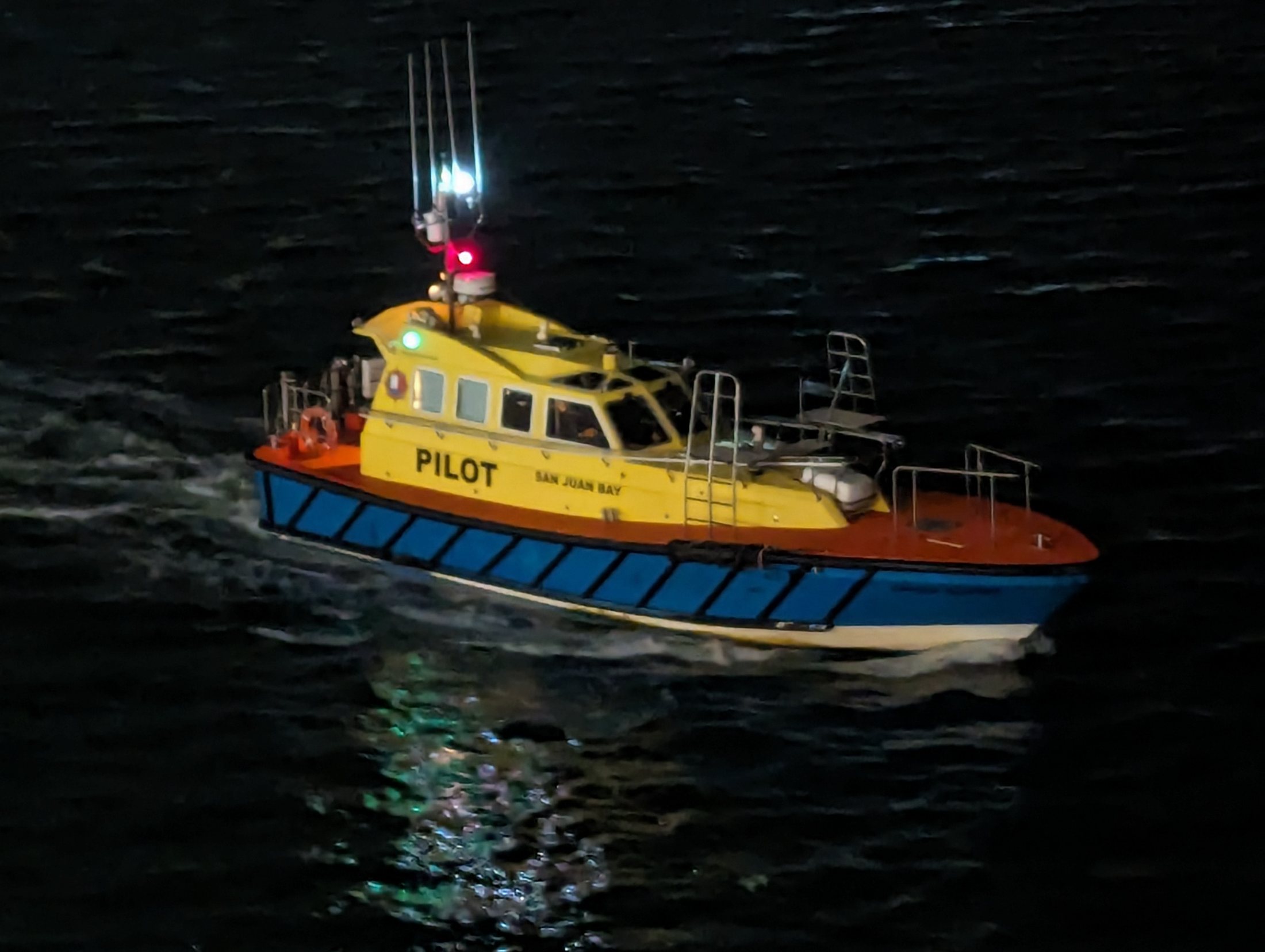 Harbor pilot boat at night