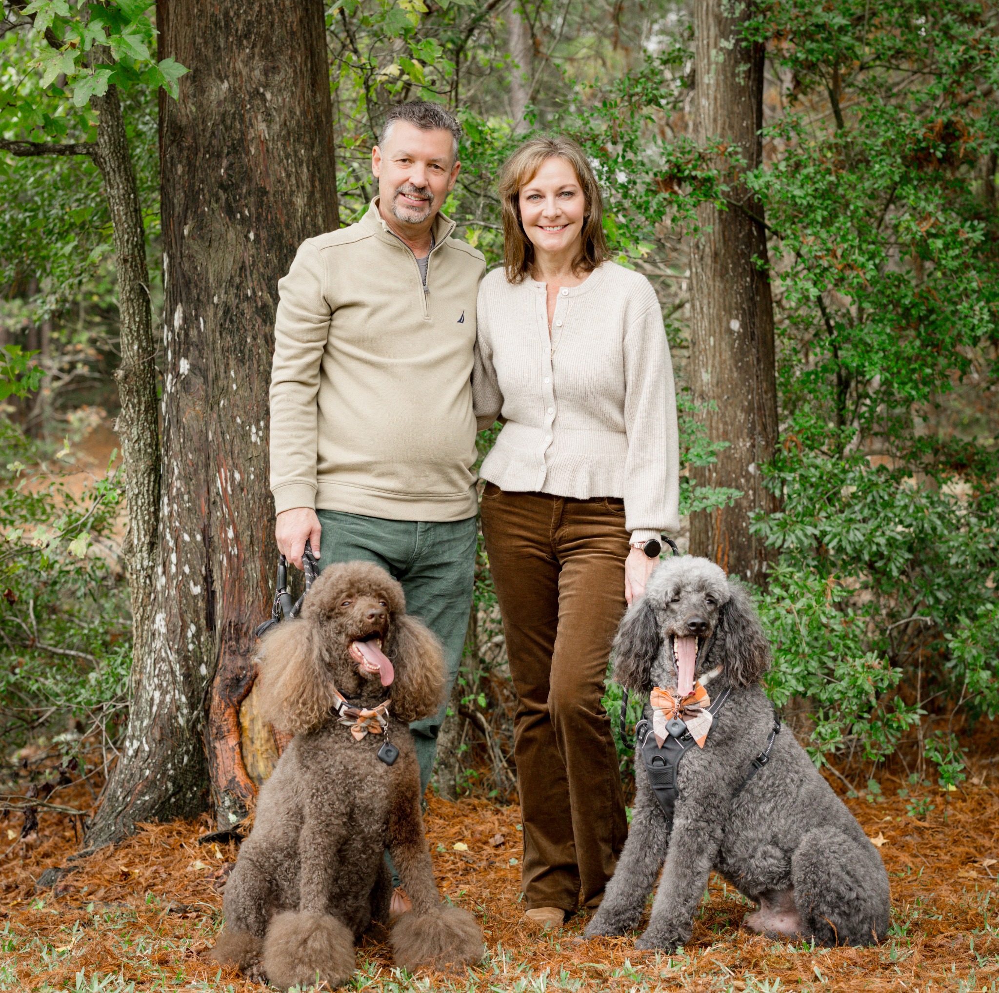 The ZosoPage family standing outdoors with their dogs